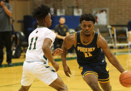 Two basketball players on a court - subject of story (Mike) dribbling